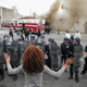 A woman faces down a line of Baltimore police officers in riot gear during violent protests following the funeral of Freddie Gray, April 27, 2015, in Baltimore.
Chip Somodevilla/Getty Images